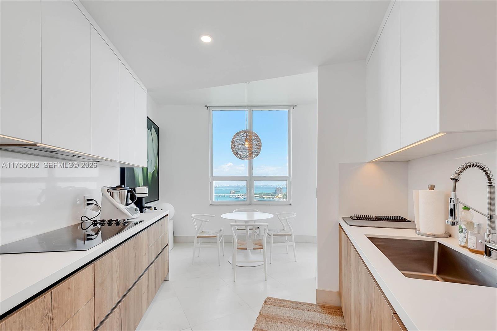 848 Brickell Key Drive, Unit 4002 Miami, FL 33131 - Photo 7 of 18 a kitchen with a sink cabinets and appliances