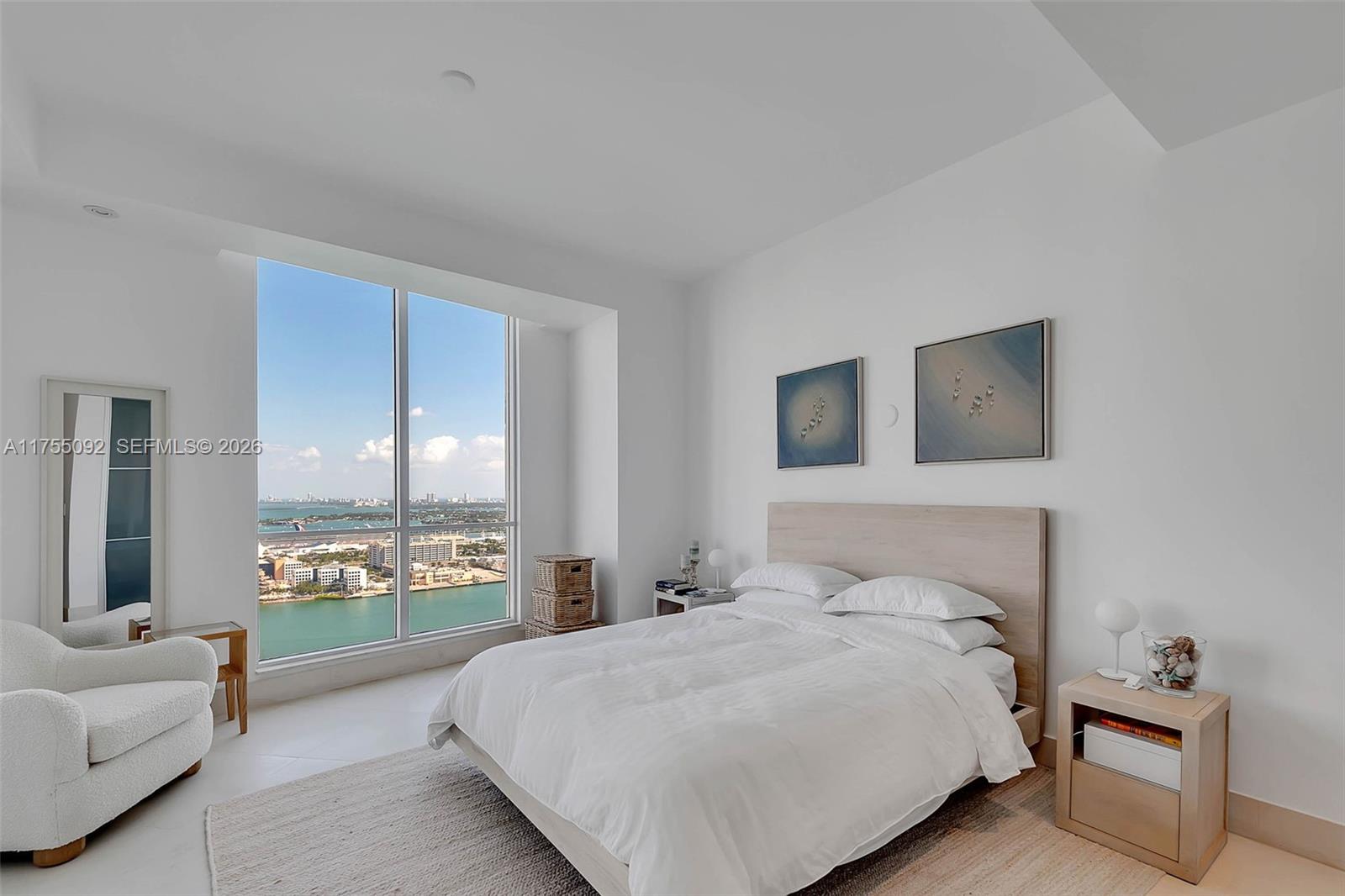 848 Brickell Key Drive, Unit 4002 Miami, FL 33131 - Photo 10 of 18 a bedroom with a bed and a couch