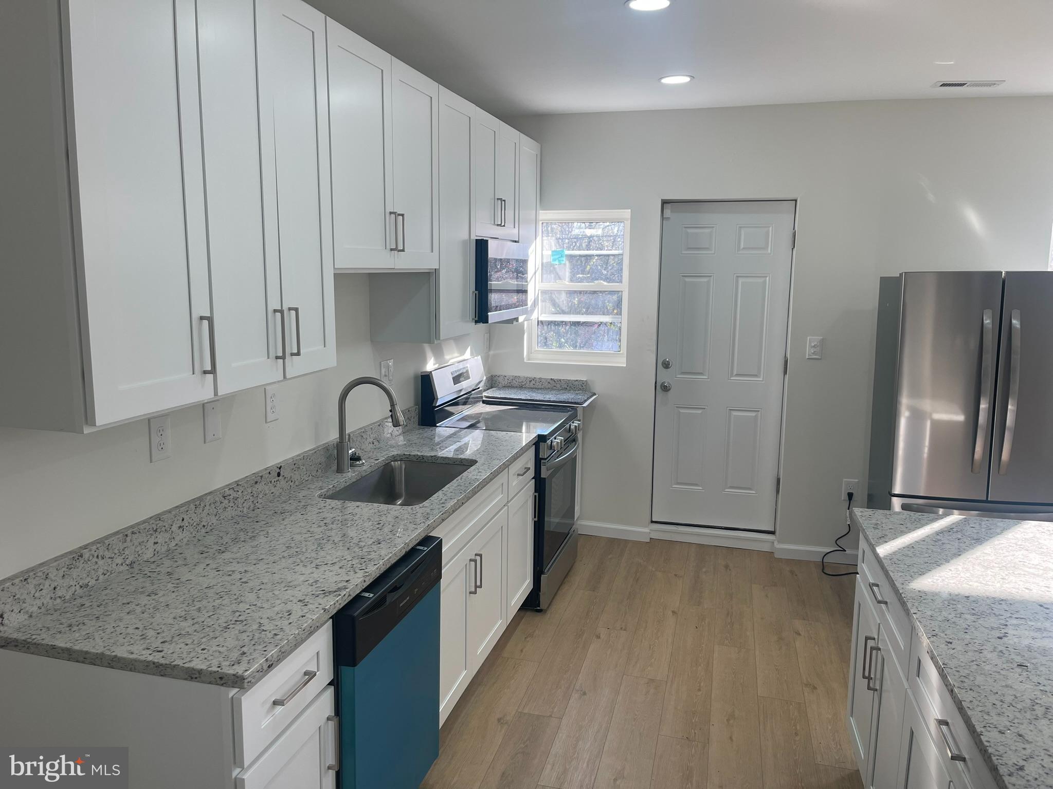 4111 Roland View Avenue Baltimore, MD 21215 - Photo 2 of 10 a kitchen with stainless steel appliances granite countertop a sink stove and refrigerator