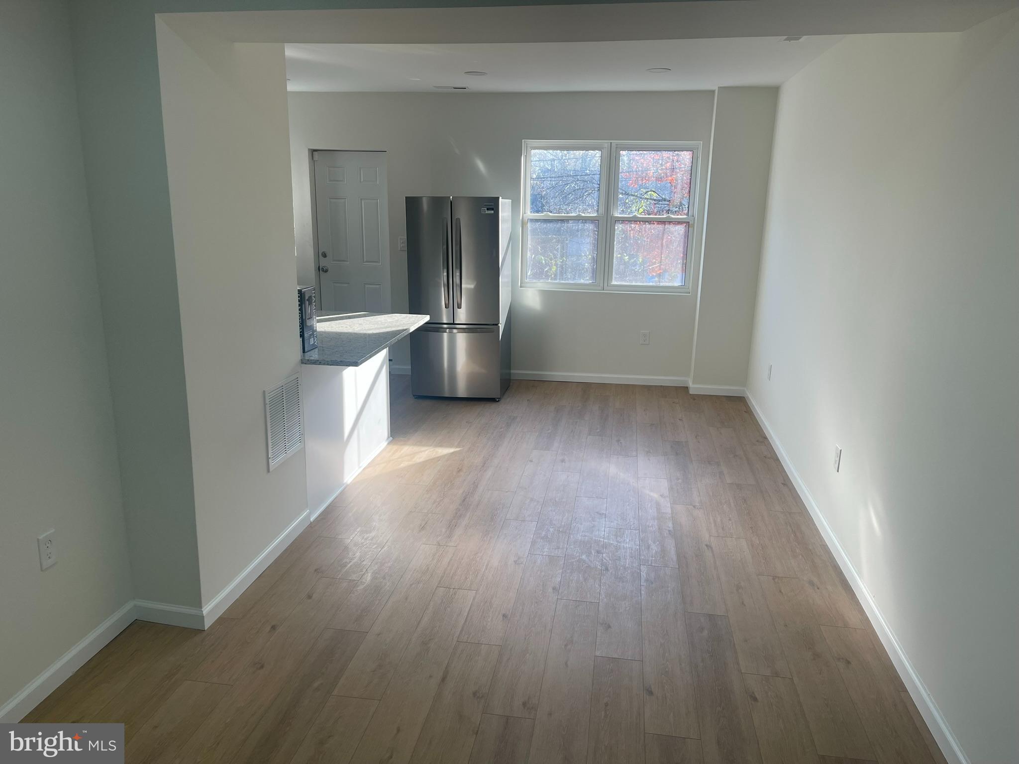 4111 Roland View Avenue Baltimore, MD 21215 - Photo 3 of 10 wooden floor in an empty room with a window