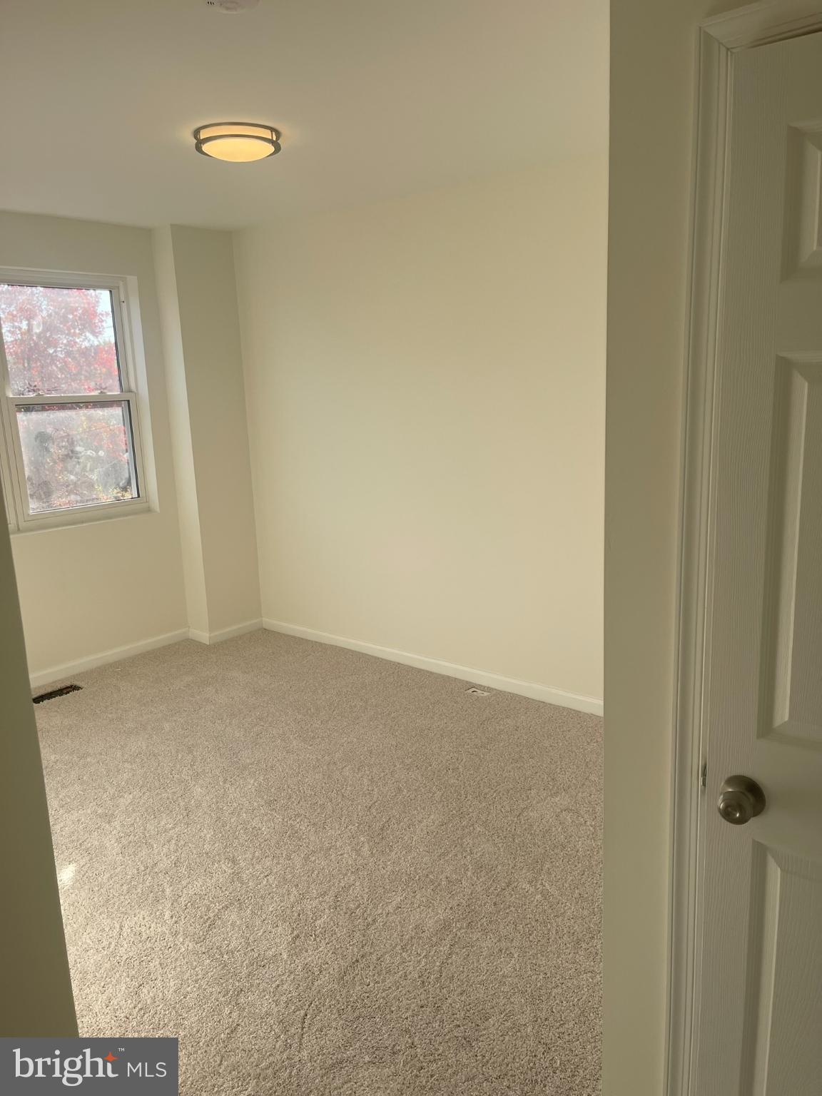 4111 Roland View Avenue Baltimore, MD 21215 - Photo 4 of 10 an empty room with windows