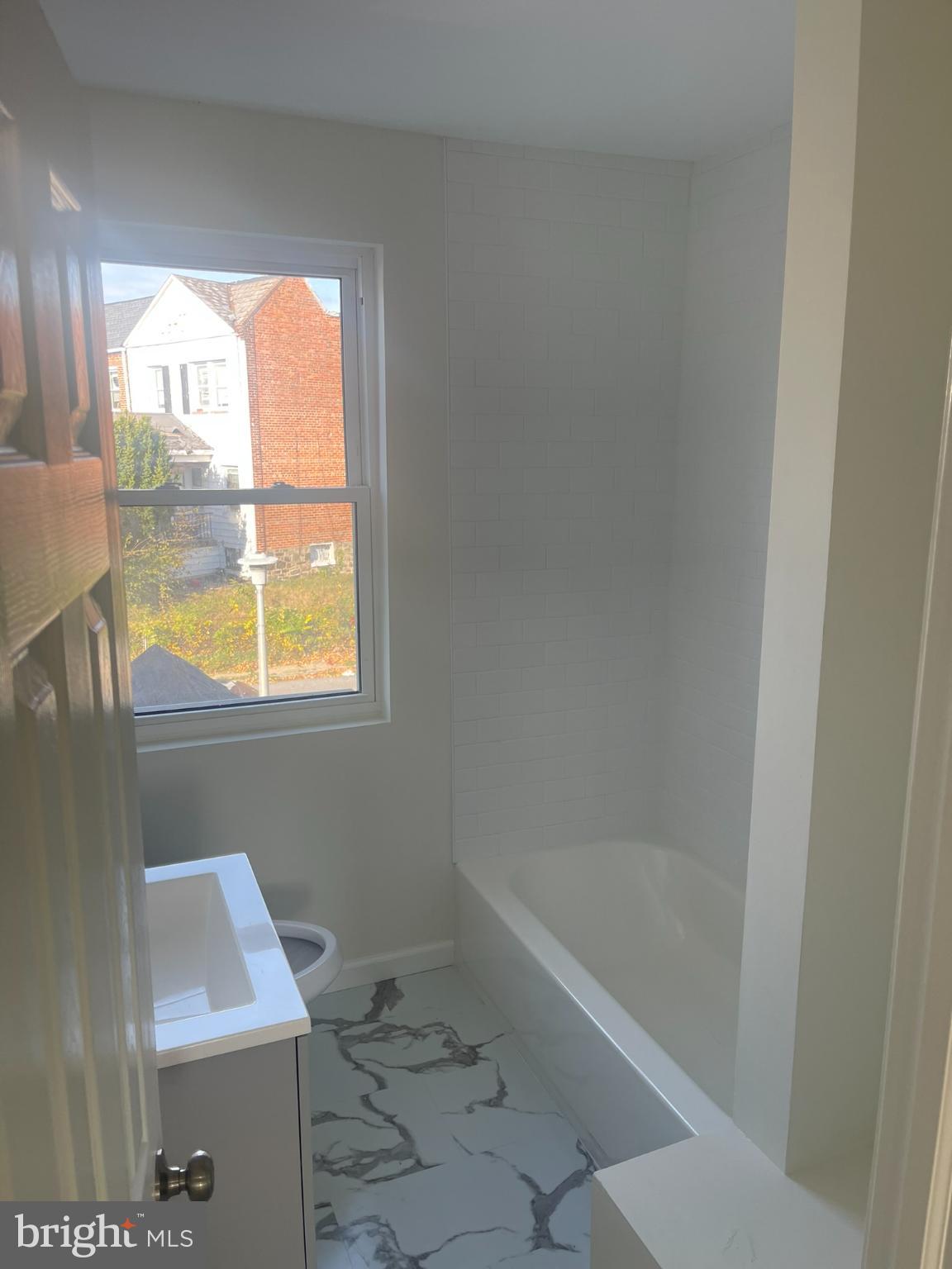 4111 Roland View Avenue Baltimore, MD 21215 - Photo 7 of 10 a bath tub sitting next to a window