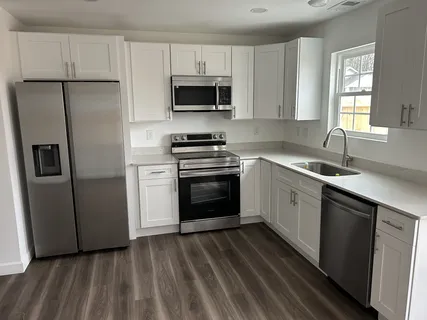 a kitchen with a sink stove and refrigerator