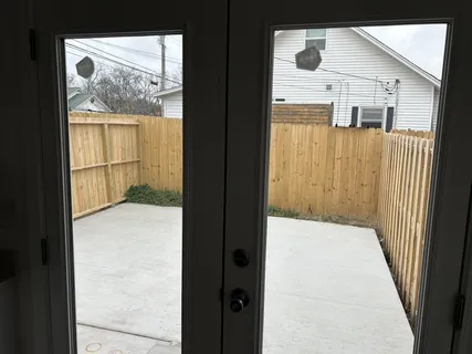a backyard of a house with wooden fence