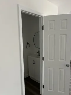 a white toilet sitting next to a shower