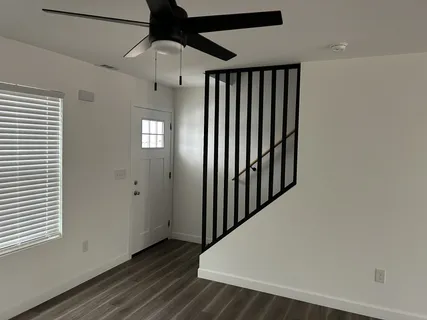 a view of a hallway with wooden floor
