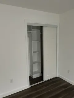 a view of a room with wooden floor