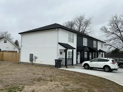 a view of a car park in front of a house