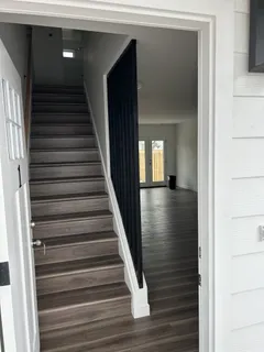a view of entryway and hall with wooden floor
