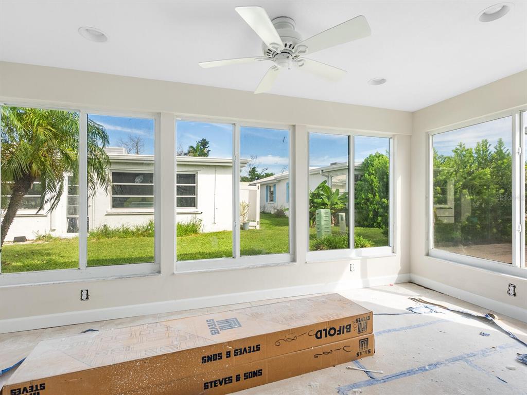 667 El Centro Longboat Key, FL 34228 - Photo 11 of 41 a living room with a large window and a chandelier