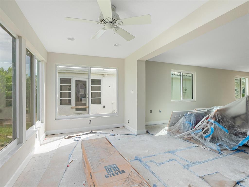 667 El Centro Longboat Key, FL 34228 - Photo 13 of 41 a bedroom with a bed and glass door