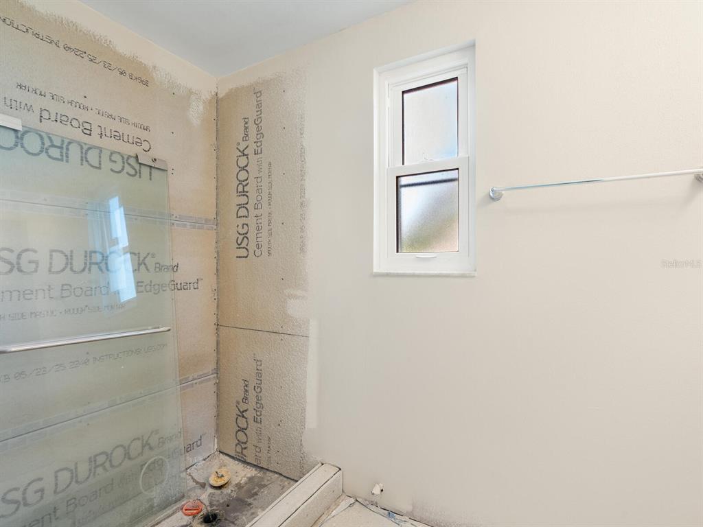 667 El Centro Longboat Key, FL 34228 - Photo 16 of 41 a bathroom with a window and a shower