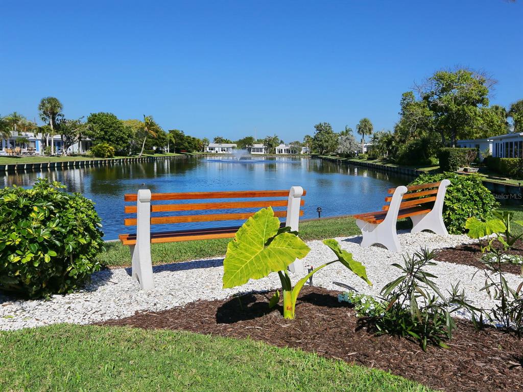 667 El Centro Longboat Key, FL 34228 - Photo 24 of 41 a view of a lake with a bench and lake view
