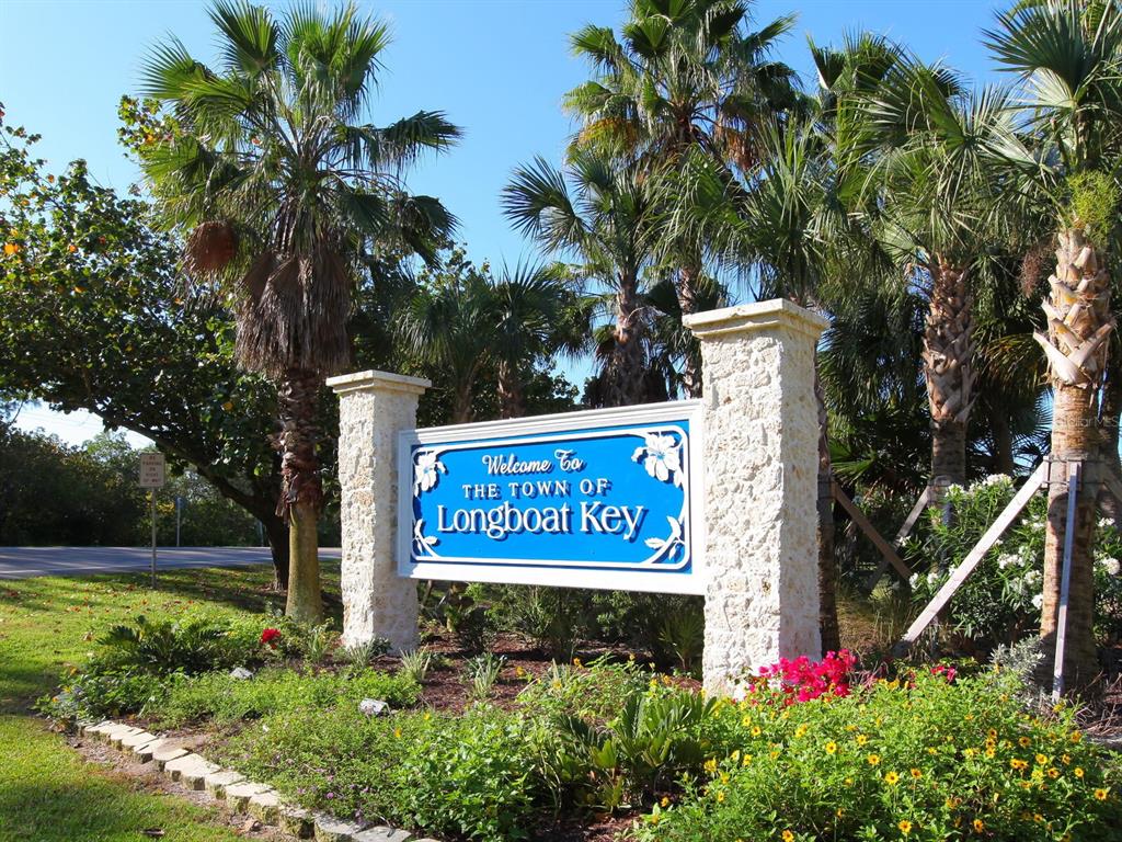667 El Centro Longboat Key, FL 34228 - Photo 33 of 41 a sign that is sitting in front of flowers