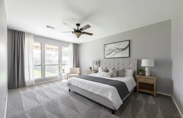 a spacious bedroom with a large bed and a large window