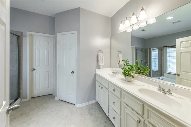a bathroom with a double vanity sink and a mirror