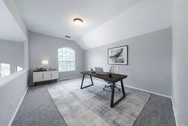 a view of a livingroom with furniture and a window