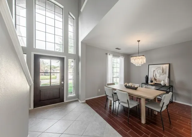 a view of a dining room with furniture and window