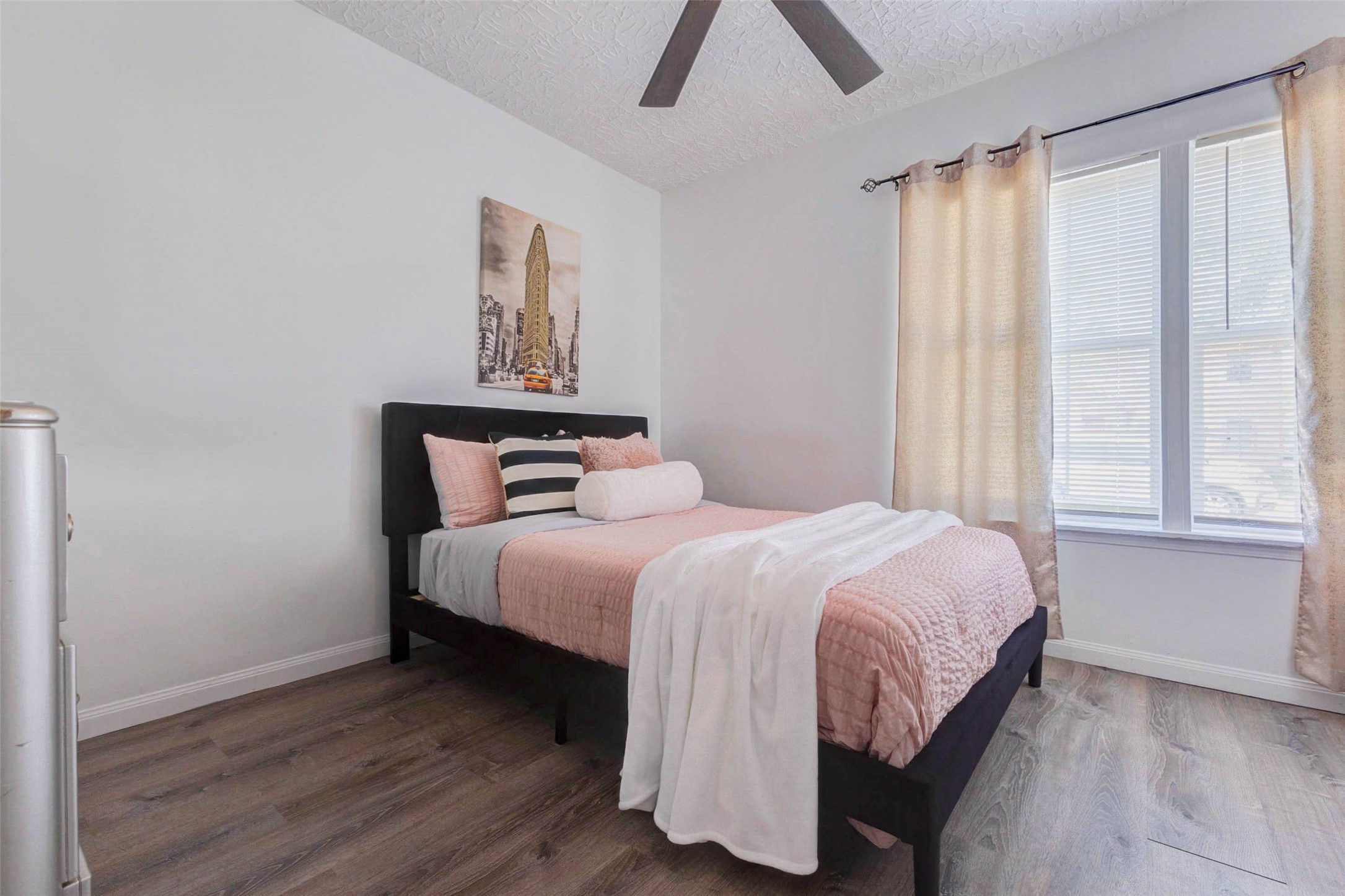 2902 Truxillo Street Houston, TX 77004 - Photo 11 of 32 a bedroom with a bed and wooden floor