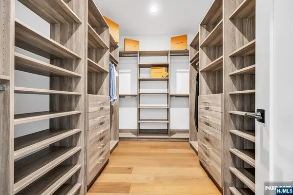 a view of walk in closet with empty racks
