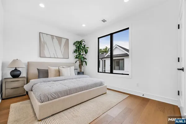 a bedroom with a bed and a painting on the wall