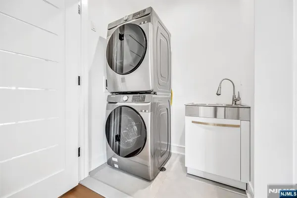 a close view of a utility room with dryer and washer
