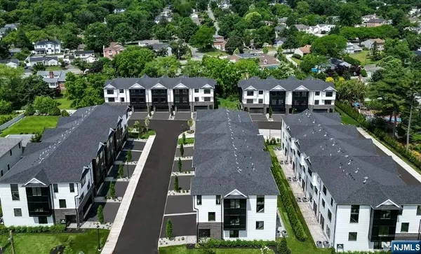 an aerial view of multiple houses with yard