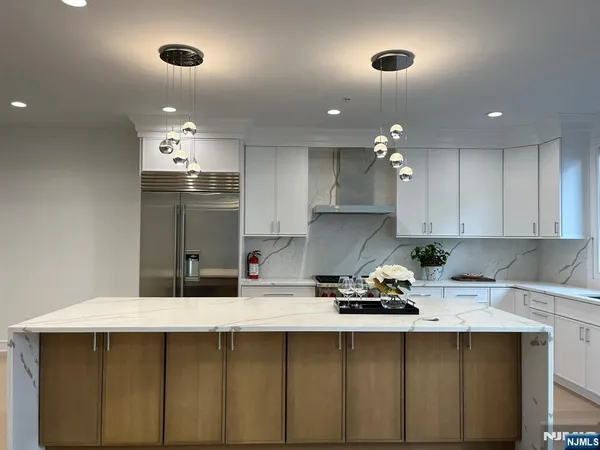 a kitchen with cabinets a sink stainless steel appliances and cabinets
