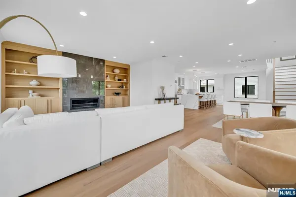 a living room with furniture fireplace and wooden floor