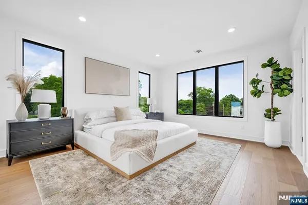 a spacious bedroom with a large bed and a large window