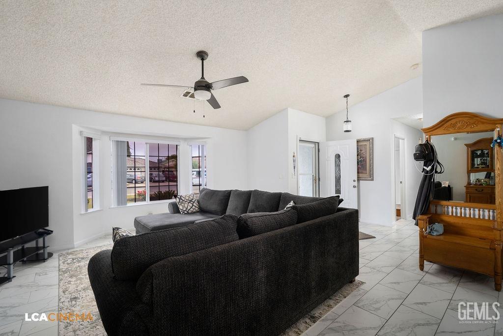 Undisclosed Address Delano, CA 93215 - Photo 12 of 35 a living room with furniture a flat screen tv and a window