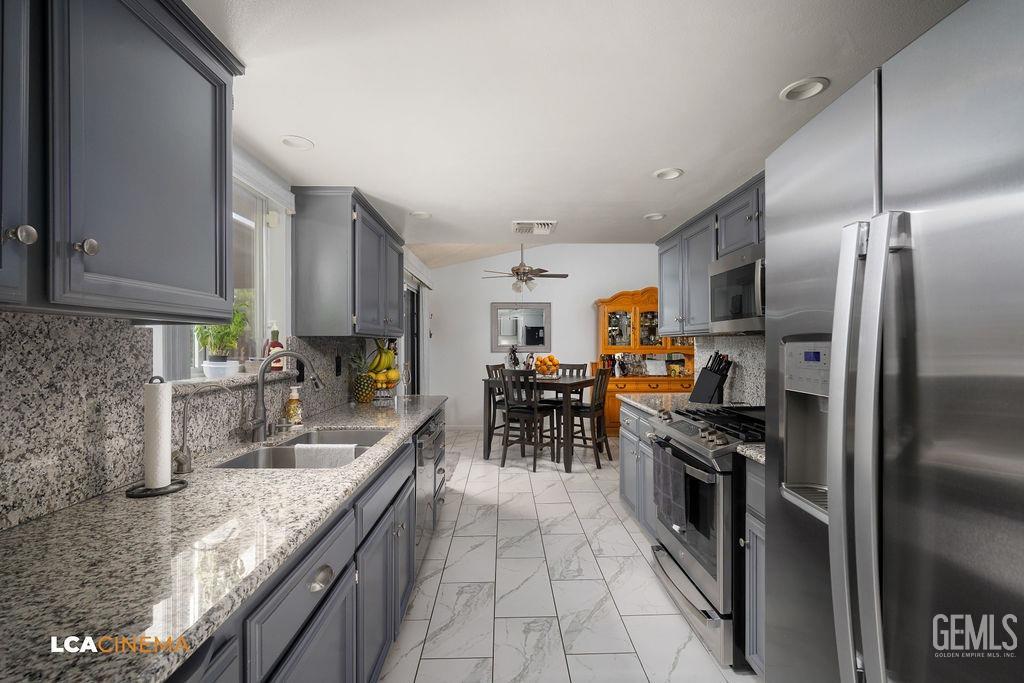 Undisclosed Address Delano, CA 93215 - Photo 16 of 35 a kitchen with stainless steel appliances granite countertop a sink stove and refrigerator