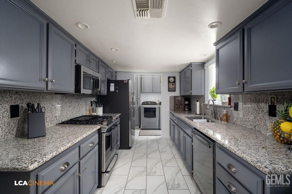 Undisclosed Address Delano, CA 93215 - Photo 17 of 35 a kitchen with stainless steel appliances granite countertop a sink stove microwave and cabinets
