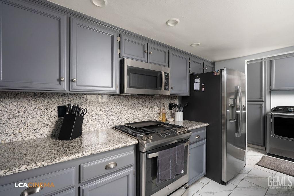 Undisclosed Address Delano, CA 93215 - Photo 18 of 35 a kitchen with granite countertop a sink and steel stainless steel appliances