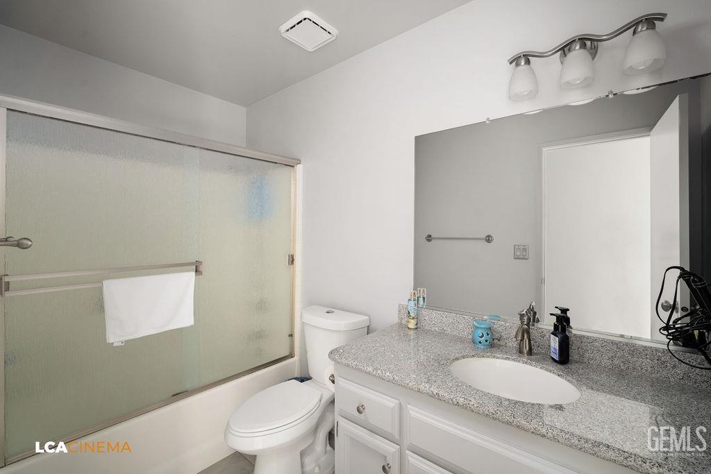 Undisclosed Address Delano, CA 93215 - Photo 22 of 35 a bathroom with a granite countertop sink a toilet and a mirror