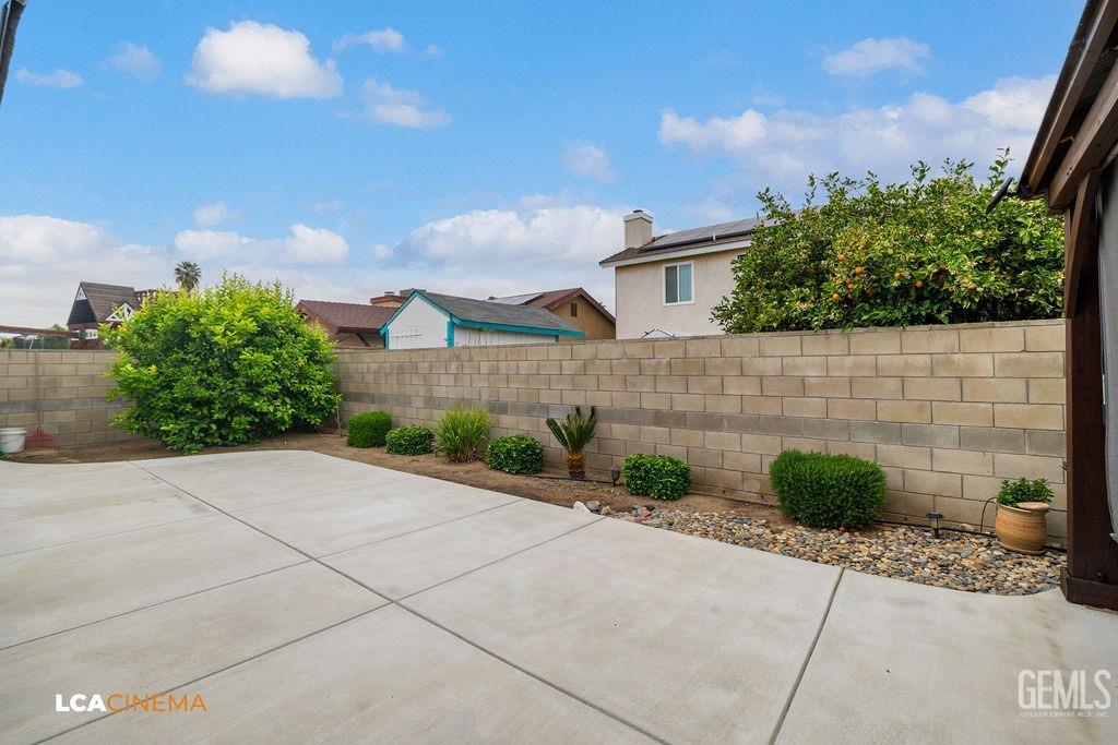 Undisclosed Address Delano, CA 93215 - Photo 29 of 35 a front view of a house with a yard and potted plants