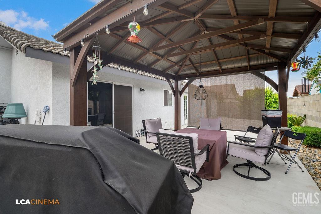 Undisclosed Address Delano, CA 93215 - Photo 32 of 35 a view of a patio with table and chairs and potted plants