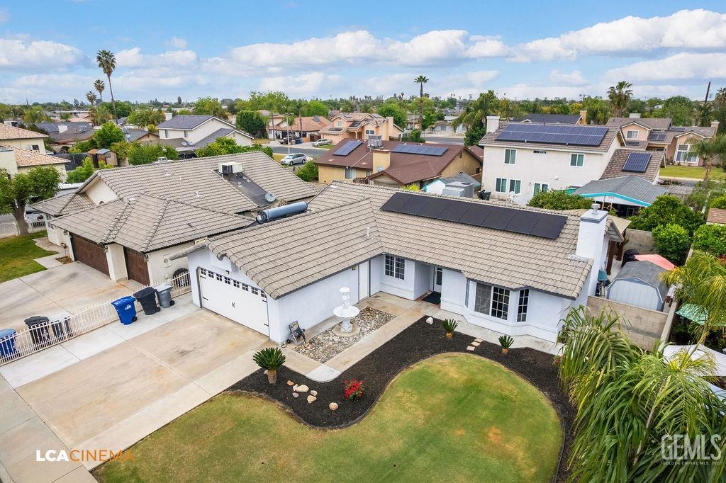 Undisclosed Address Delano, CA 93215 - Photo 7 of 35 an aerial view of a house with a big yard and large trees