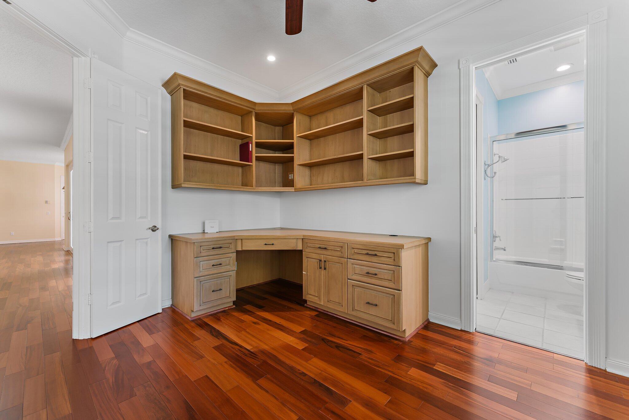 215 New Haven Boulevard Jupiter, FL 33458 - Photo 18 of 42 a view of an empty room with wooden floor and a cabinet