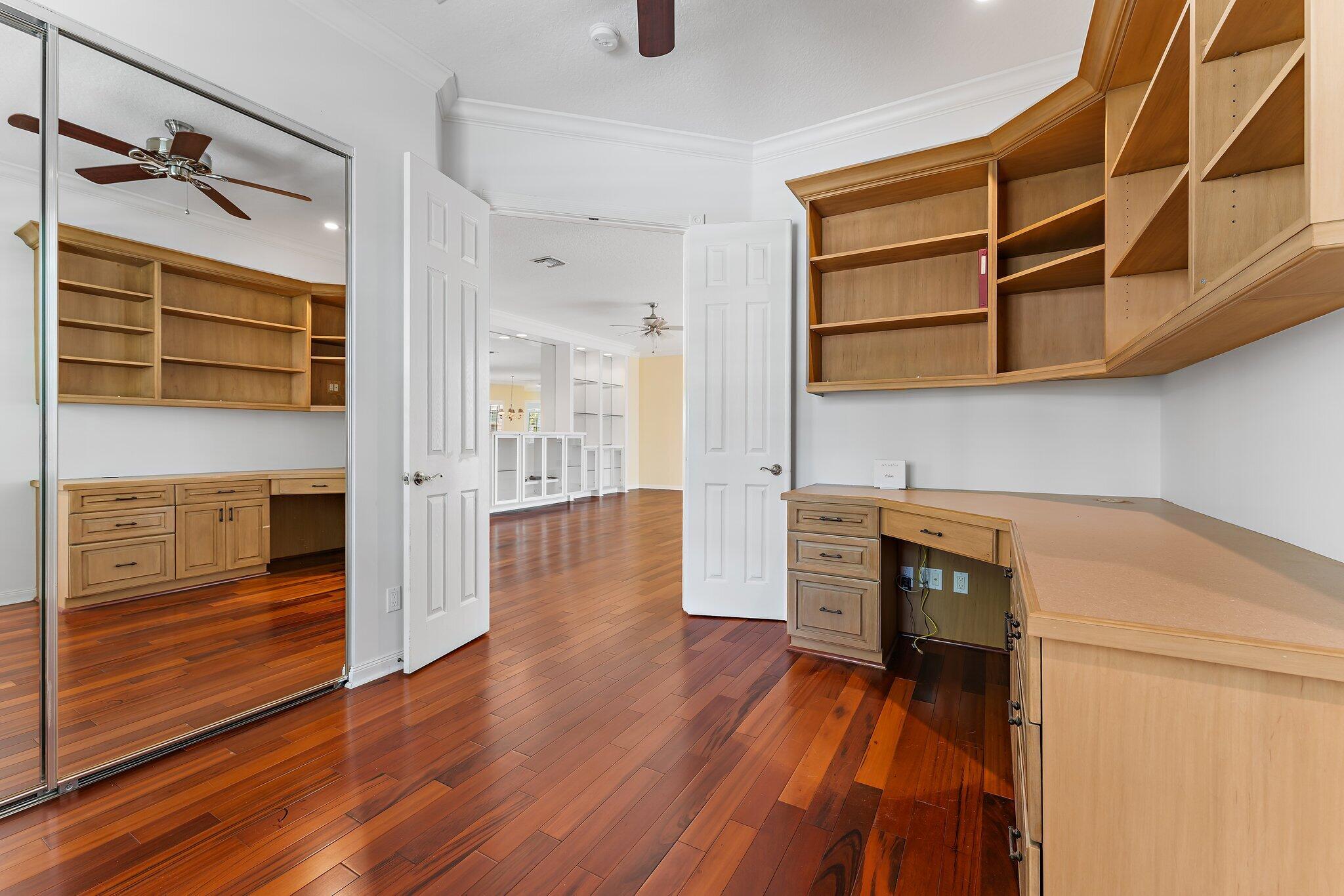 215 New Haven Boulevard Jupiter, FL 33458 - Photo 19 of 42 a view of a kitchen with wooden floor and cabinets
