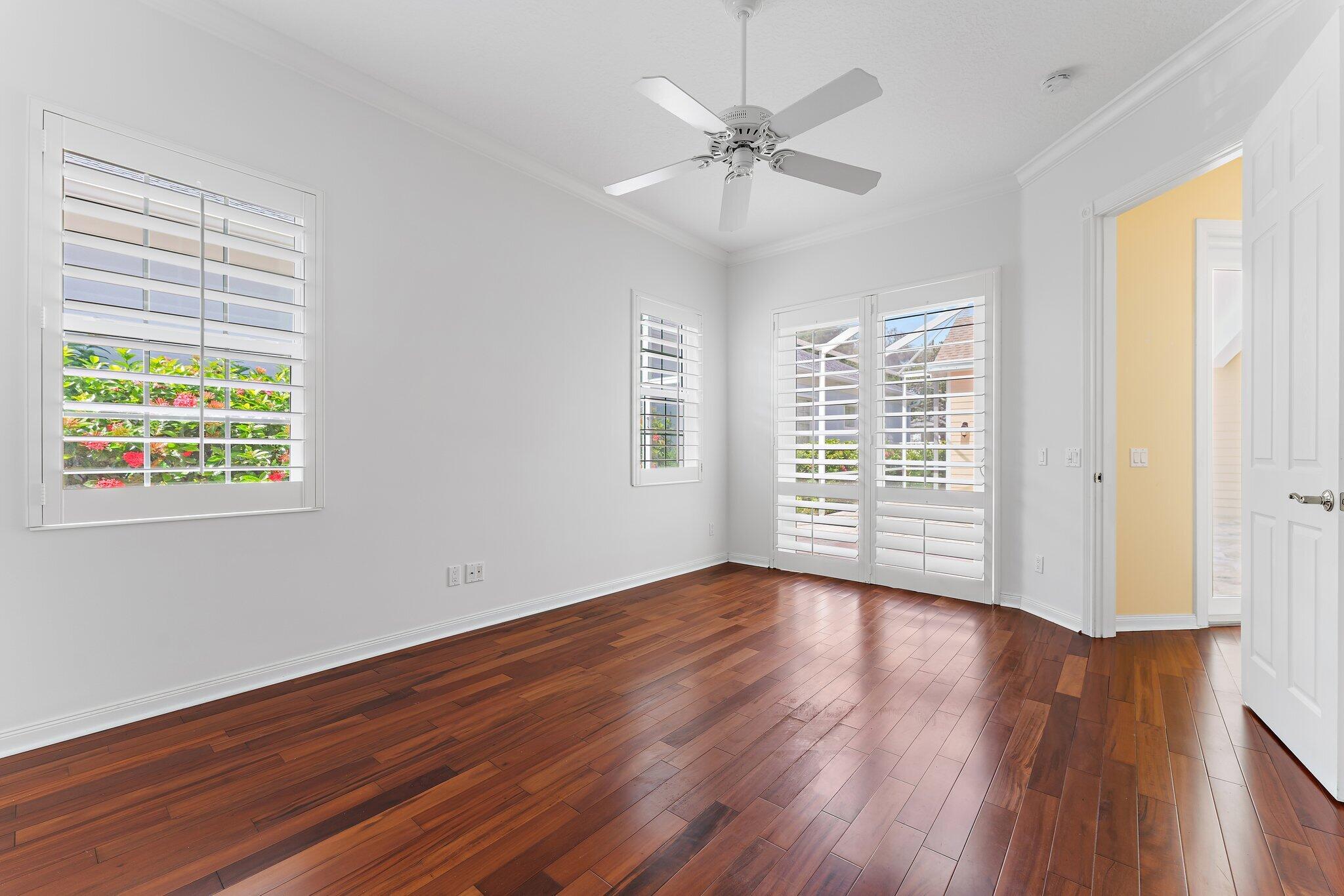 215 New Haven Boulevard Jupiter, FL 33458 - Photo 29 of 42 a view of an empty room with wooden floor and a window