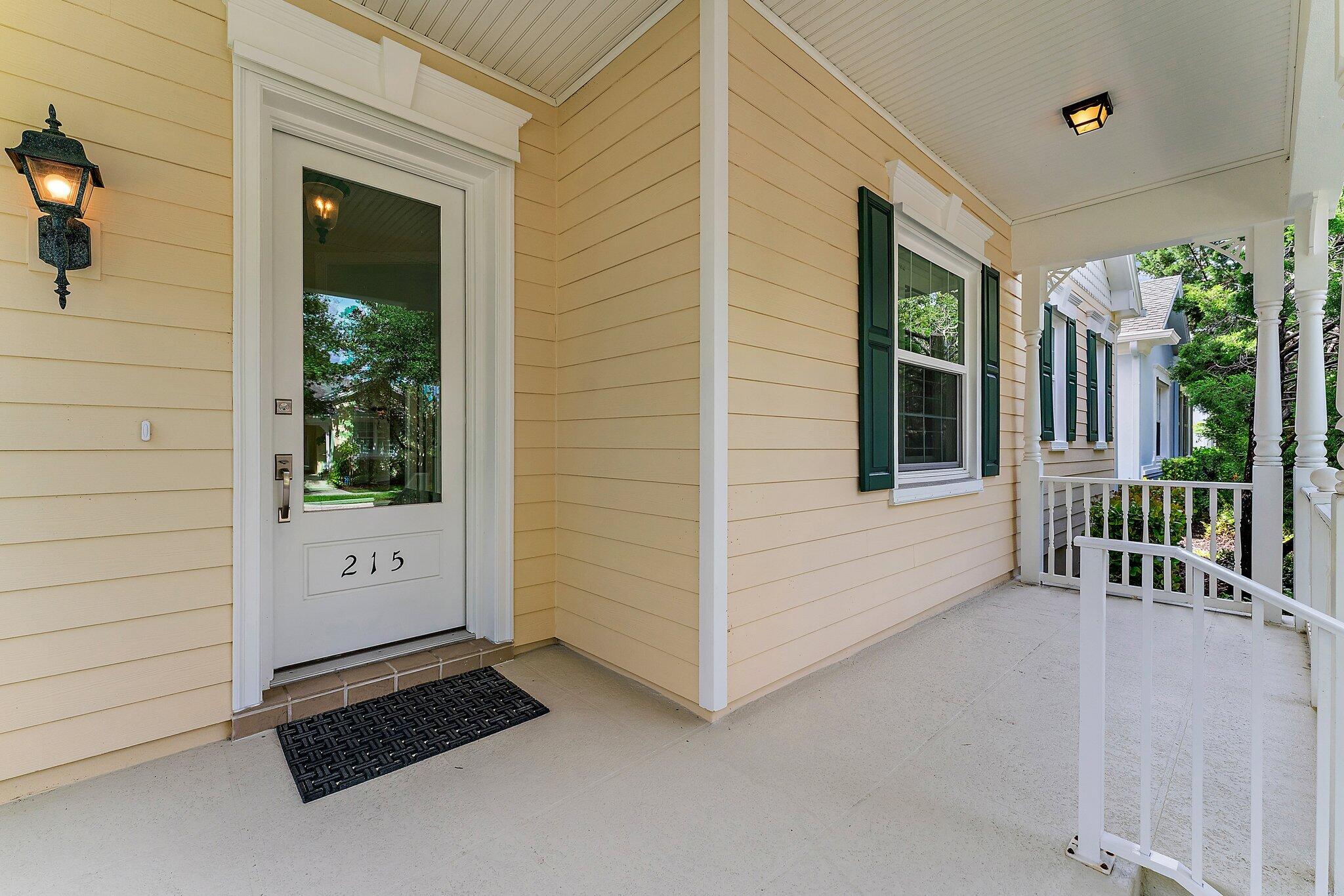 215 New Haven Boulevard Jupiter, FL 33458 - Photo 3 of 42 a view of a porch with a table and chair