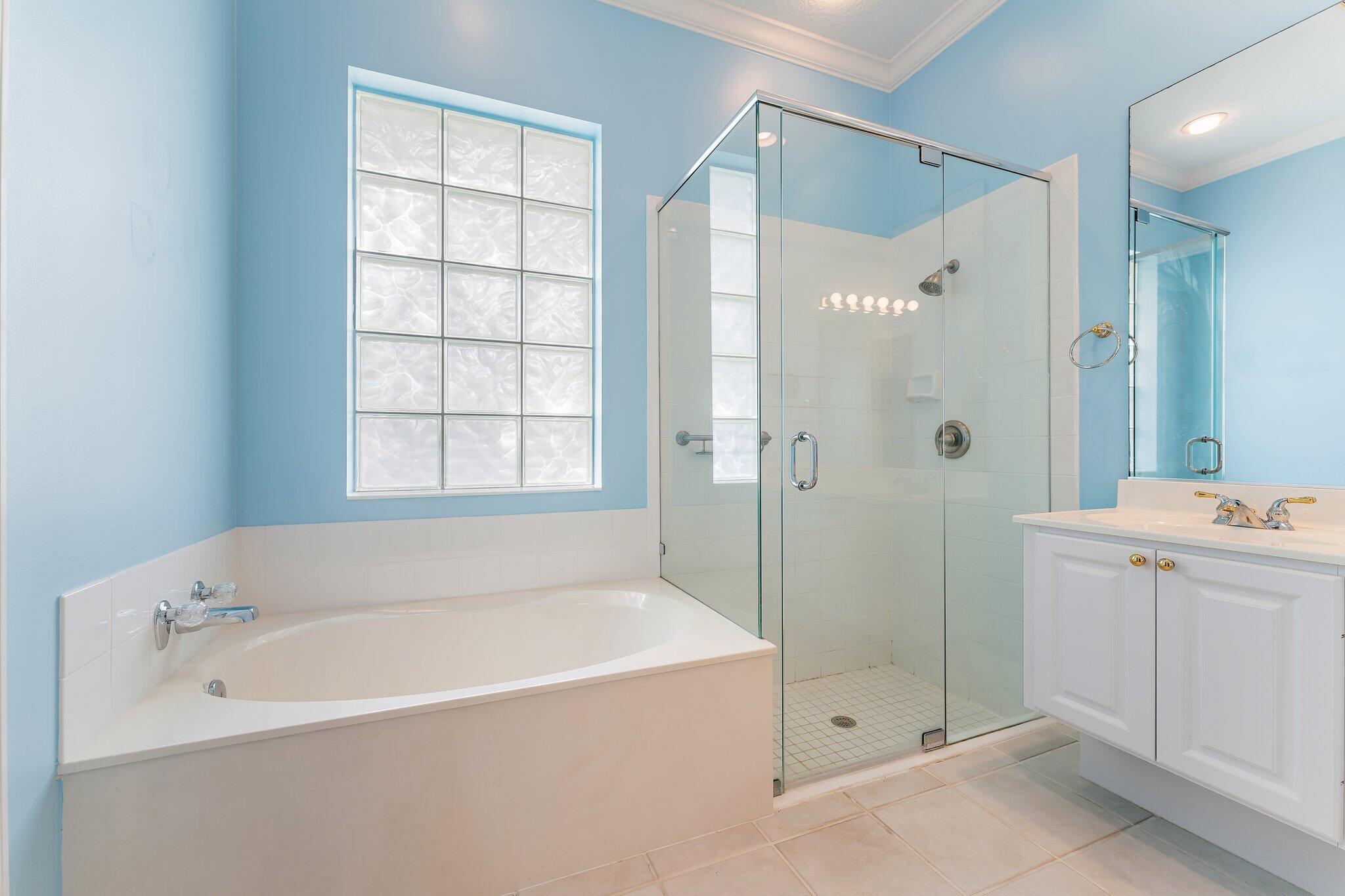 215 New Haven Boulevard Jupiter, FL 33458 - Photo 32 of 42 a white bath tub sitting next to a shower