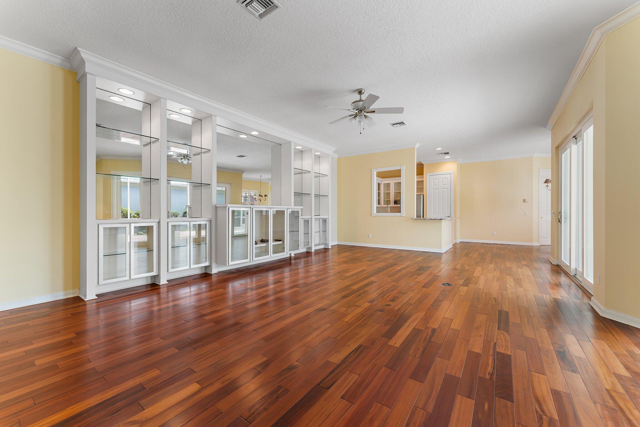 215 New Haven Boulevard Jupiter, FL 33458 - Photo 6 of 42 a view of a big room with wooden floor and windows
