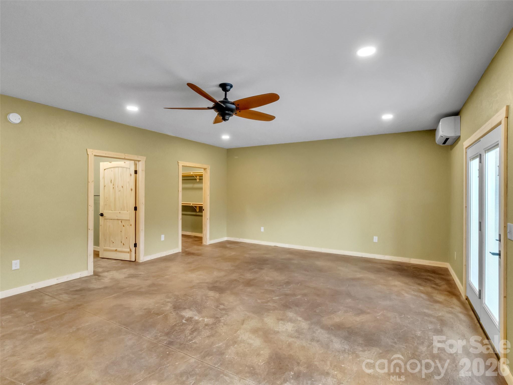 171 Cowtail Cove Clyde, NC 28721 - Photo 33 of 48 an empty room with windows and painted walls