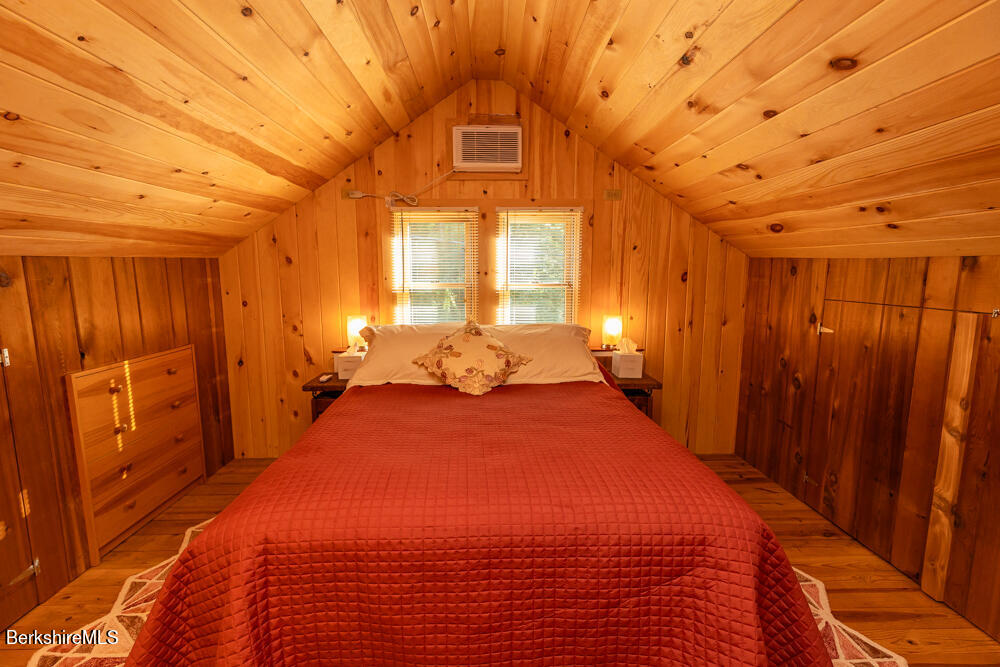 3 Indian Road Stockbridge, MA 01262 - Photo 16 of 23 a bedroom with a bed and a chandelier