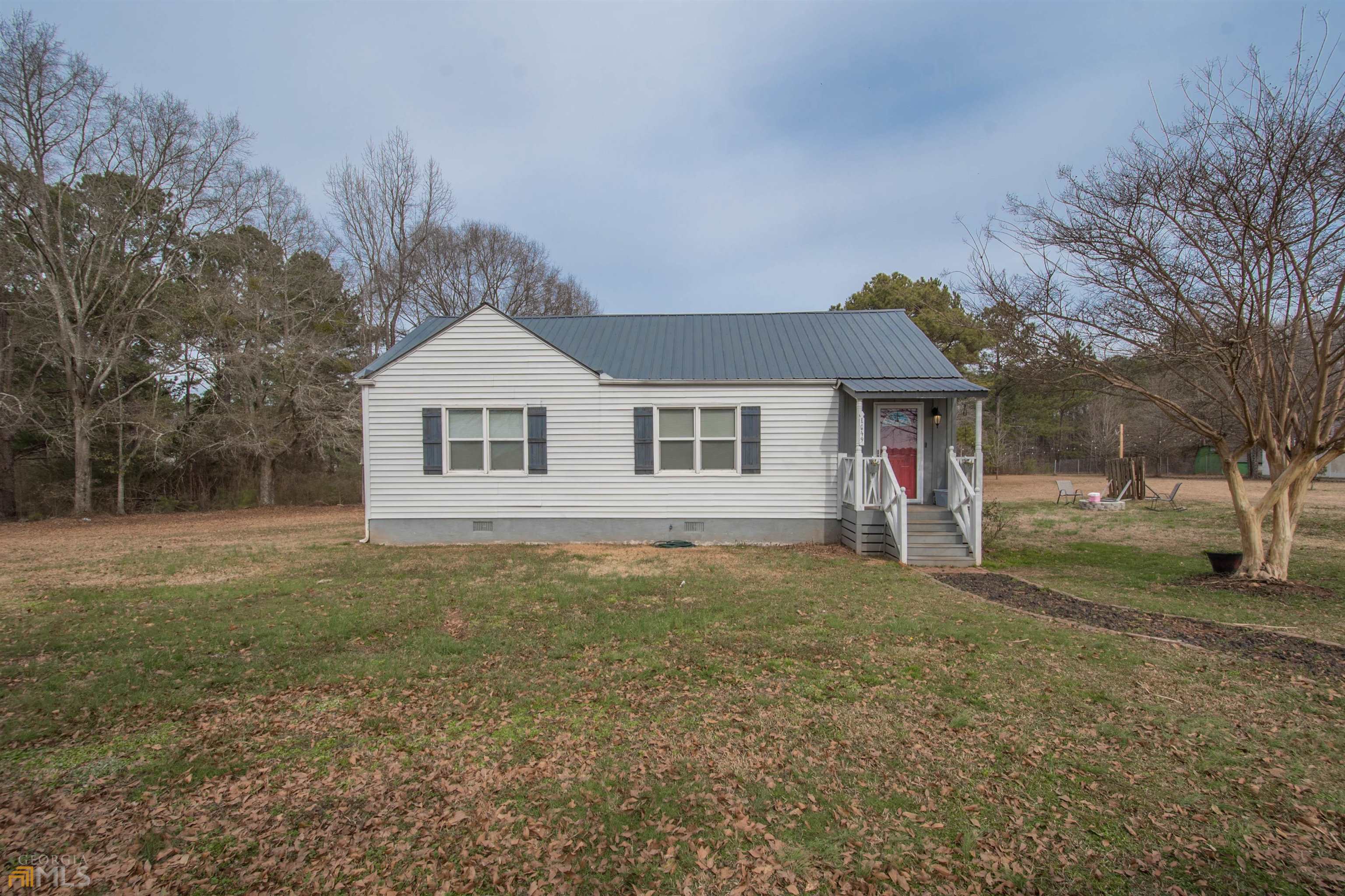 1649 Peeksville Road Locust Grove, GA 30248 - Photo 1 of 1 a front view of a house with a garden