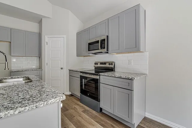 a kitchen with a sink and large window