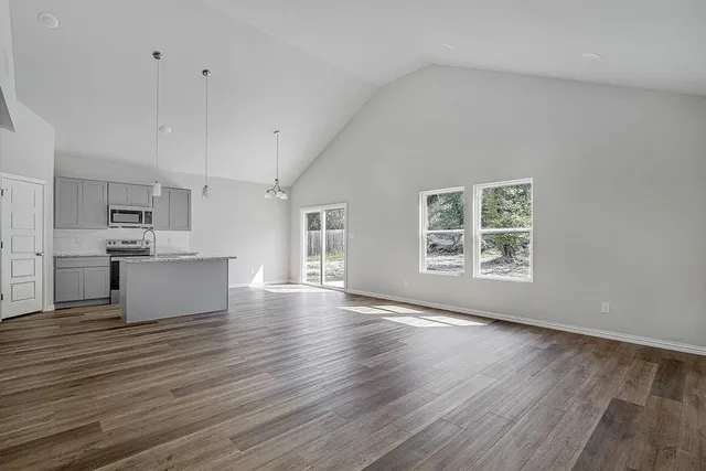 a view of kitchen with microwave and cabinets