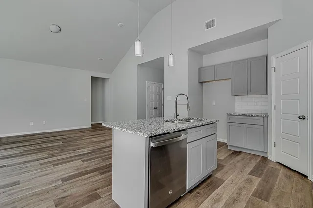 a kitchen with stainless steel appliances granite countertop a stove and a microwave